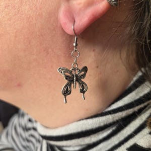 Silver-colored butterfly drop earring