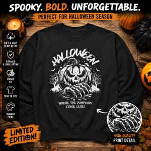 May include: A black crewneck sweatshirt featuring a white graphic of a jack-o'-lantern with clawed hands emerging from the bottom. The text reads HALLOWEEN WHERE THE PUMPKINS COME ALIVE. The design includes silhouettes of bare trees and bats.
