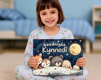 May include: A hardcover children's book titled Goodnight Kynnedi with a dark blue night sky cover featuring a yellow moon, stars, and illustrations of a fox, sloth, bear, hedgehog, and rabbit sleeping on a floral patterned blanket.