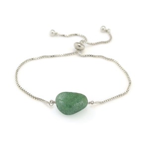 May include: A silver chain bracelet with an adjustable sliding clasp and a single green stone bead.