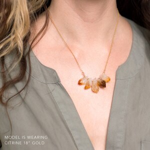 May include: A gold chain necklace with a cluster of raw citrine crystals. The necklace is 18 inches long and is made of gold.  MODEL IS WEARING CITRINE 18" GOLD
