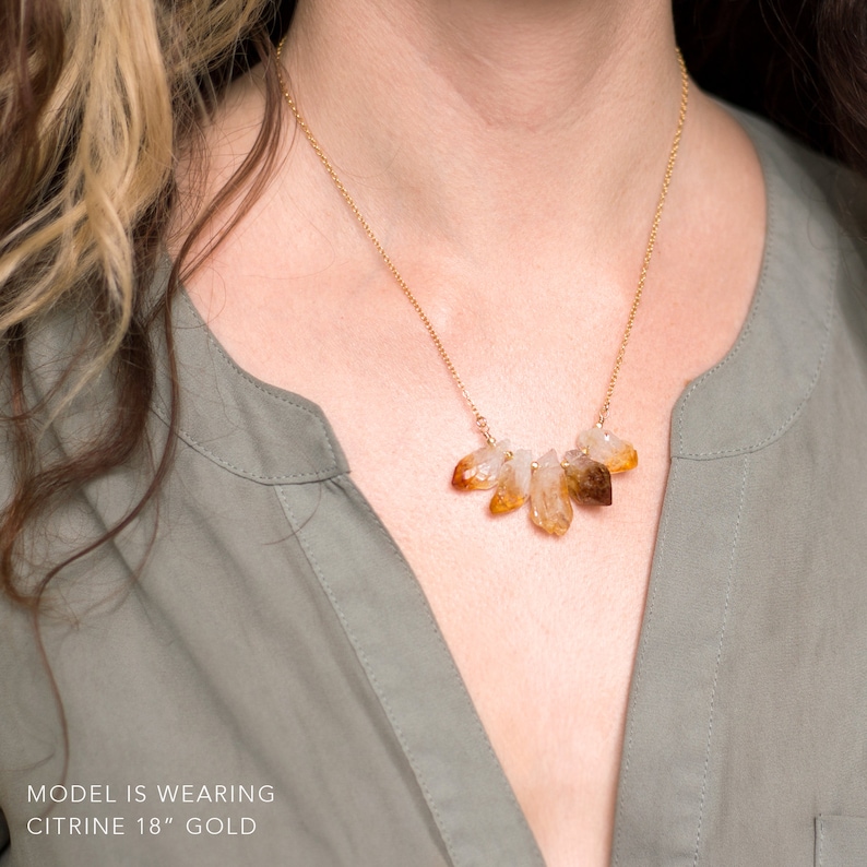 May include: A gold chain necklace with a cluster of raw citrine crystals. The necklace is 18 inches long and is made of gold.  MODEL IS WEARING CITRINE 18" GOLD