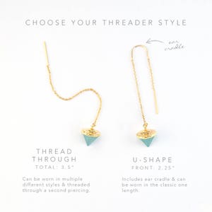 May include: Two gold threader earrings with a light blue gemstone. The earring on the left is a thread through style with a total length of 3.5 inches. The earring on the right is a U-shape style with a front length of 2.25 inches.  The U-shape style includes an ear cradle.