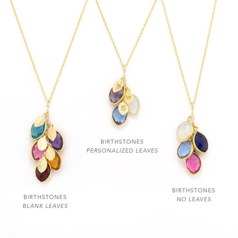 May include: Three gold necklaces with birthstone charms. The first necklace has blank gold leaves with birthstones. The second necklace has personalized leaves with birthstones. The third necklace has birthstones without leaves. Birthstones Personalized Leaves, Birthstones Blank Leaves, Birthstones No Leaves.