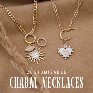 May include: Two gold charm necklaces with different pendants. One necklace has a sun, moon, cloud, and circle charm. The other necklace has a heart-shaped charm with an eye design. The text "CUSTOMIZABLE CHARM NECKLACES" is at the bottom of the image.