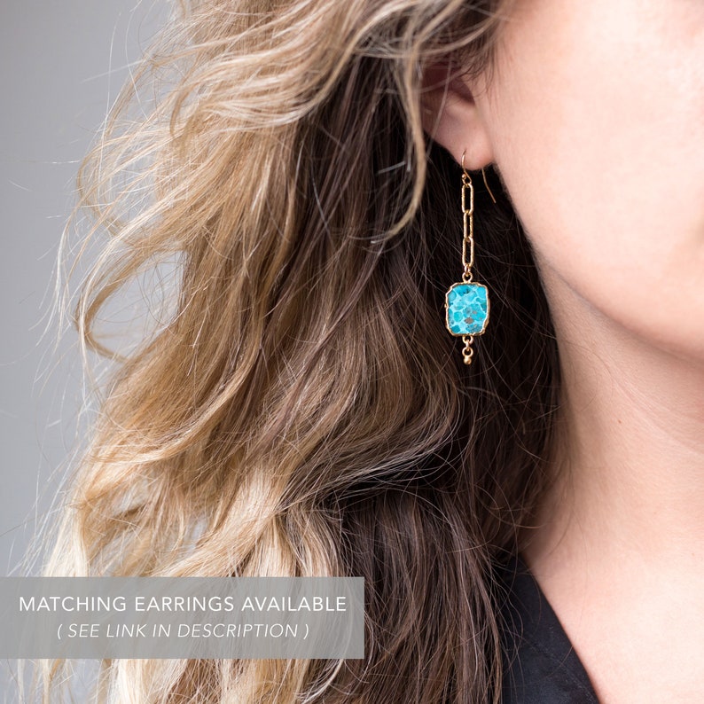 May include: Gold dangle earrings with a turquoise blue square stone and a chain link design.