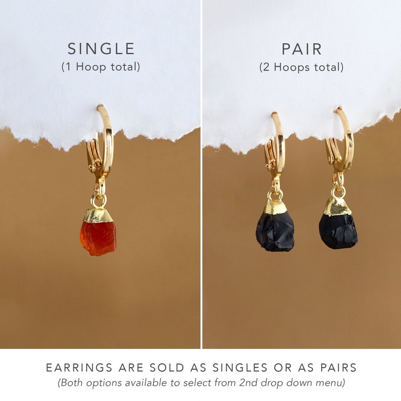 May include: Gold hoop earrings with a choice of either a red carnelian or black obsidian stone pendant. The earrings are available as a single or a pair. "EARRINGS ARE SOLD AS SINGLES OR AS PAIRS (Both options available to select from 2nd drop down menu)" text is included in the image.