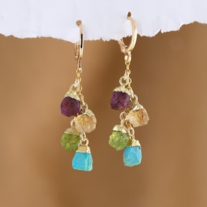 May include: Gold dangle earrings with a cluster of turquoise, green, yellow, and purple gemstone beads.