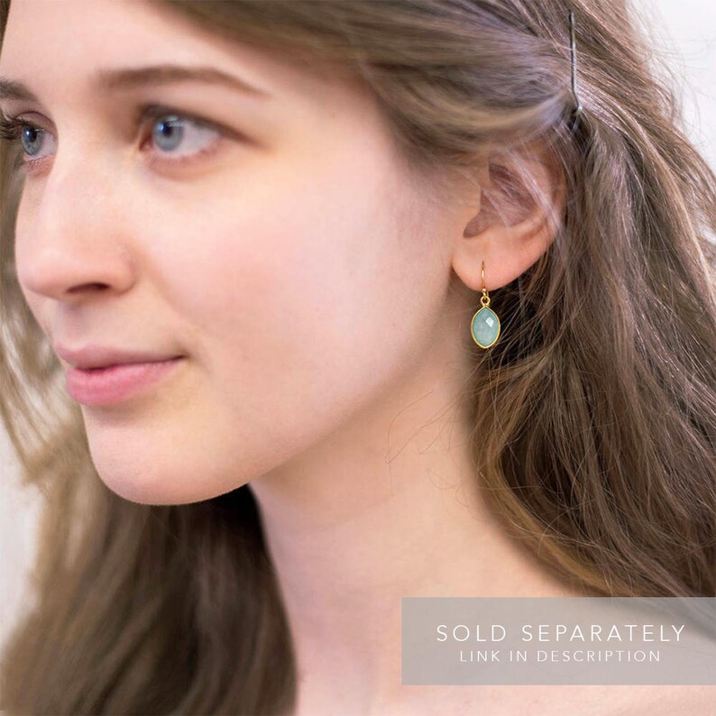 May include: A pair of gold earrings with a light blue gemstone. The earrings are sold separately.  SOLD SEPARATELY LINK IN DESCRIPTION