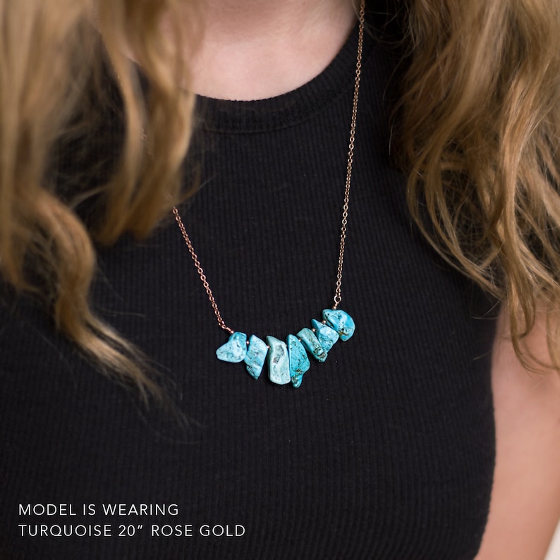 May include: A turquoise gemstone necklace with rose gold chain. The necklace is 20 inches long and features a row of turquoise stones.