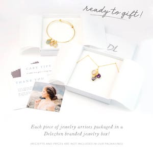 May include: A white jewelry box with a gold necklace and a gold bracelet inside. The box is open and the jewelry is visible. The box has a label that says "DL Delezen" on it. The text "ready to gift!" is written above the box. The text "Each piece of jewelry arrives packaged in a Delezen branded jewelry box! (RECIEPTS AND PRICES ARE NOT INCLUDED IN OUR PACKAGING)" is written below the box.