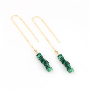 May include: A pair of gold chain earrings with green malachite stone beads. The earrings are long and dangle.
