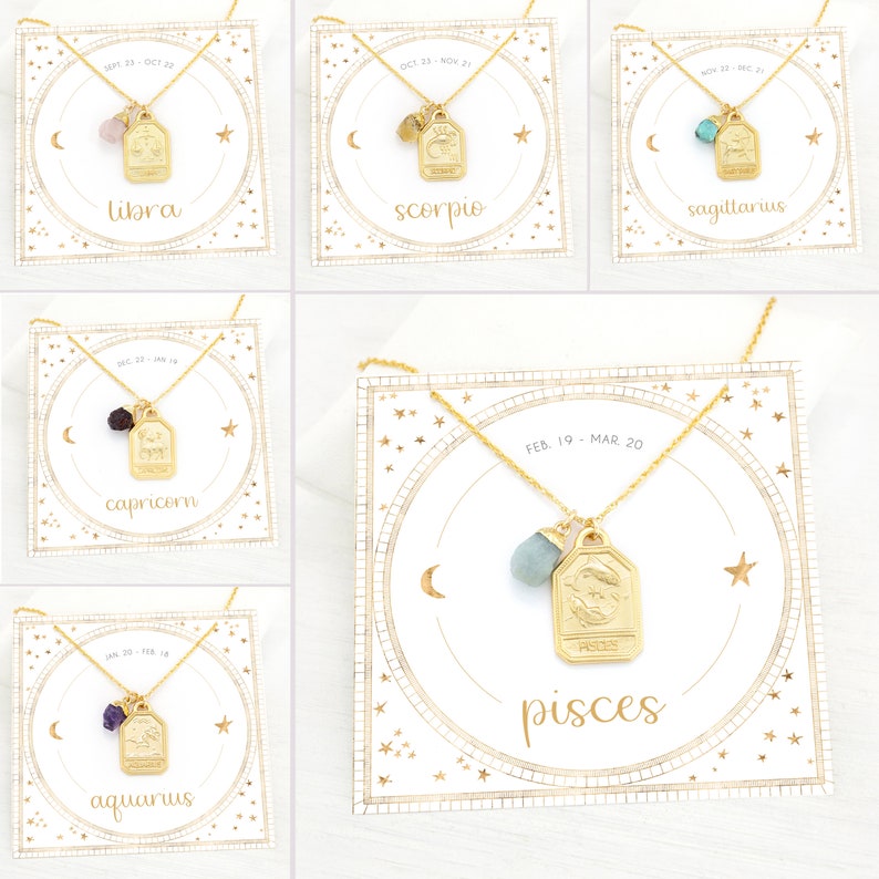 May include: Gold zodiac necklace with a gemstone charm and a gold tag with the zodiac symbol and name. The necklaces are displayed on white cards with a gold circle and stars. The cards also include the zodiac dates.