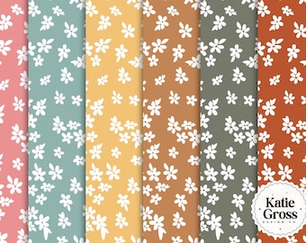 May include: A collection of floral patterns in various colors, including pink, teal, yellow, brown, olive green, and rust. Each pattern features a repeating design of small white flowers and leaves. The patterns are suitable for fabric or wallpaper.