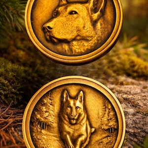 May include: Two gold-colored medallions with detailed relief images of a dog. One shows a side profile of the dog's head, the other depicts the dog running through a forest scene. The medallions are circular.
