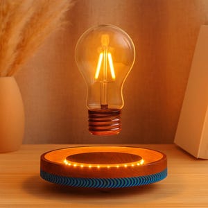 May include: A levitating light bulb with a warm, glowing filament. The bulb hovers above a wooden base with a ring of small lights. The base has a blue and brown design, creating a modern and unique lighting fixture.