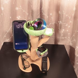 May include: A white ceramic mug with a black handle and the text "But First, Coffee" in a black, bold font. The mug is on a white surface. The mug is 4 inches tall.