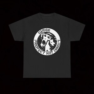 May include: Black t-shirt with a white circular graphic. The graphic includes the text "PROTECT NOT DISECT" and an illustration of a creature, with "URGE" at the top. The t-shirt has a crew neck and short sleeves.