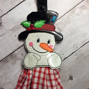 Porta-toalhas em formato de boneco de neve no bastidor com design de máquina de bordar