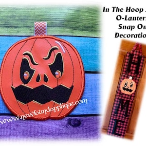 May include: A red and black Halloween-themed door hanger with the word "HOME" in black letters on a red and black plaid background. The "O" in "HOME" is replaced with a scary-faced orange pumpkin. The text "In The Hoop Jack-O-Lantern Snap On Decoration" is written above the door hanger.