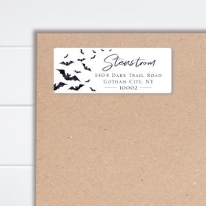 May include: White return address label with black bats flying around the edges. The text reads "Stenstrom, 1404 Dark Trail Road, Gotham City, NY 10002".