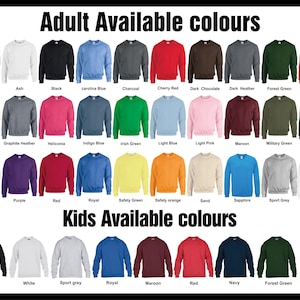 May include: A display of crewneck sweatshirts in various colors, including red, blue, and green. The image shows the available colors for adults and kids, with text indicating the color names like "Black", "White", and "Royal".