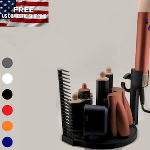 May include: A black hair styling tool organiser with various attachments and a copper-coloured curling iron. The organiser includes a comb, brushes, and other styling tools. The image is set against a neutral background.