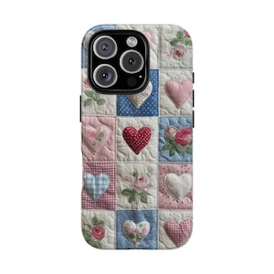 May include: A phone case featuring a patchwork design with squares of various colors and patterns. The design includes hearts, roses, and plaid patterns in shades of pink, blue, and white. The case has a black border and camera lenses.