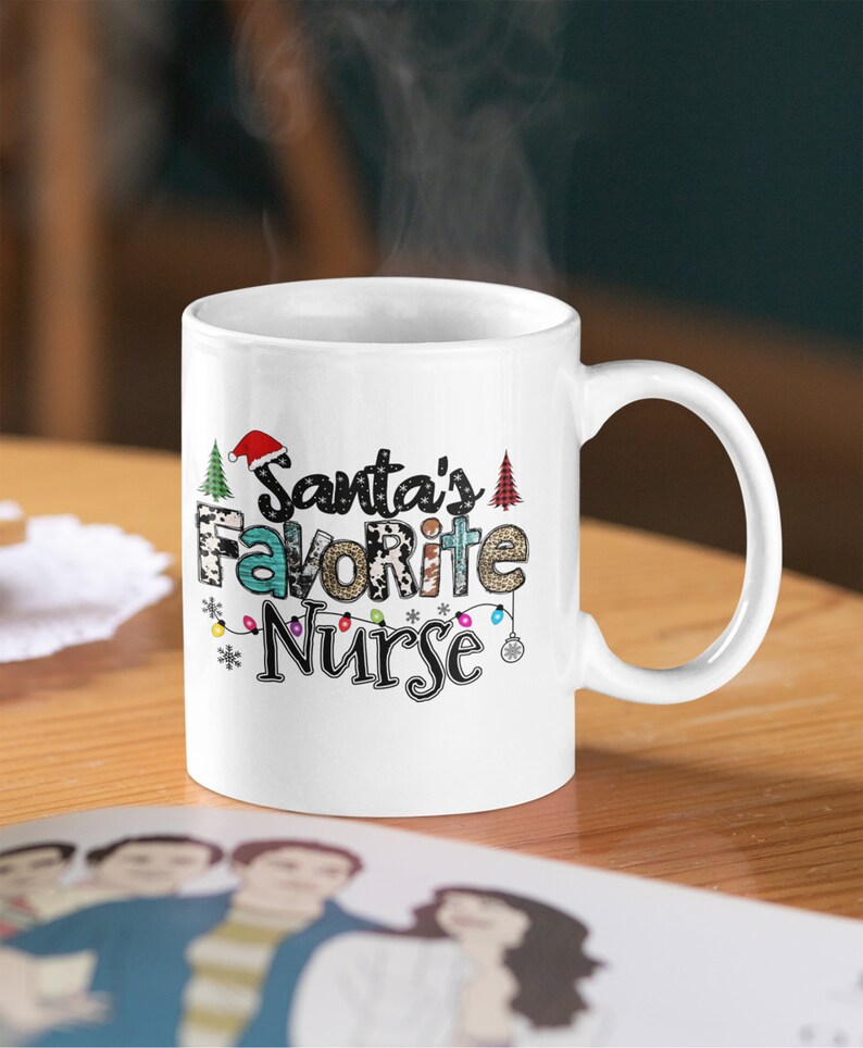 May include: White ceramic mug with a Christmas-themed design. The mug features the text "Santa's Favorite Nurse" with a red Santa hat, Christmas trees, and lights.