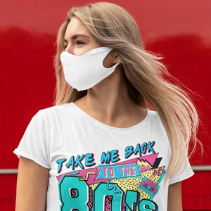 May include: White t-shirt with a colorful graphic that says "Take Me Back To The 80's". The graphic features a cassette tape, geometric shapes, and a retro color scheme.