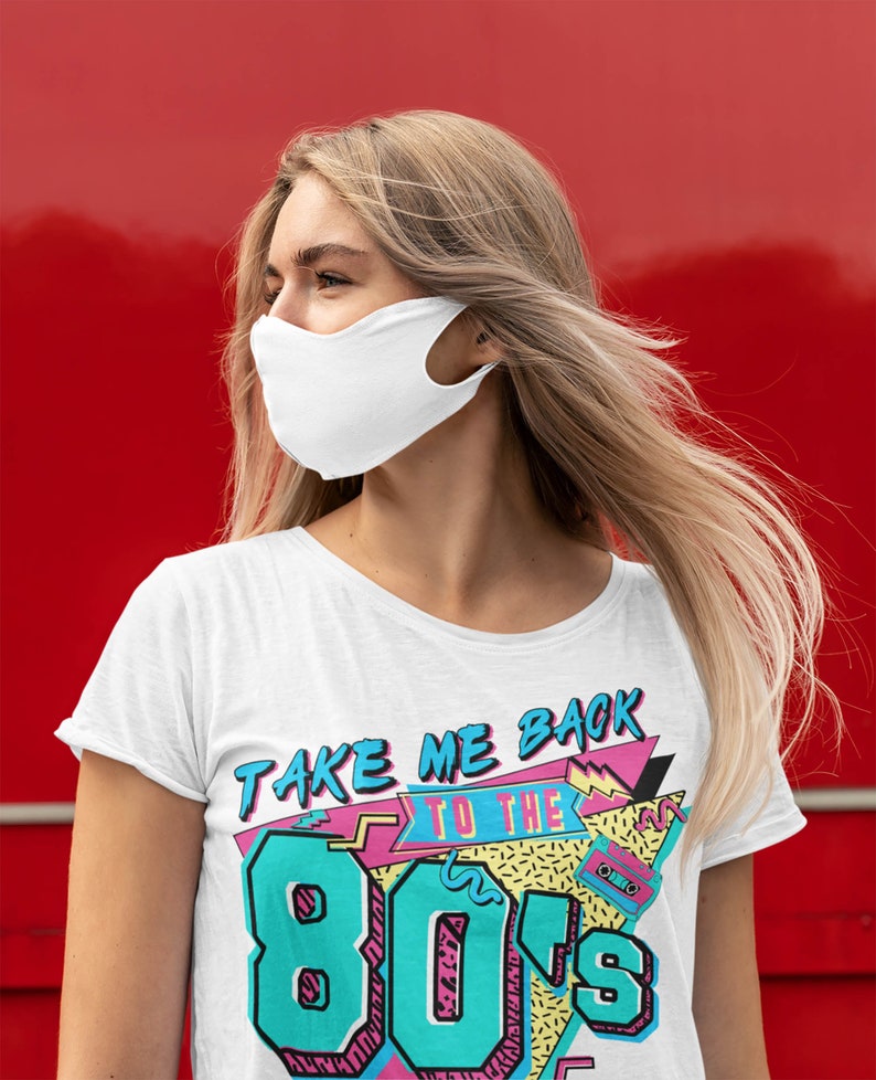 May include: White t-shirt with a colorful graphic that says "Take Me Back To The 80's". The graphic features a cassette tape, geometric shapes, and a retro color scheme.