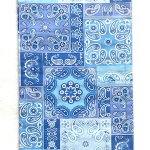 May include: A blue and white paisley patterned fabric with a patchwork design. The fabric is made of cotton and is perfect for quilting, crafts, and other projects.