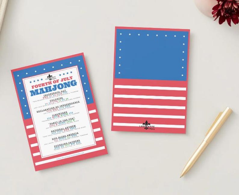 May include: Two Fourth of July Mahjong game cards. One card features a red, white, and blue design with the text "Fourth of July Mahjong" and a list of related terms. The other card has a blue top with white stars and red and white stripes.