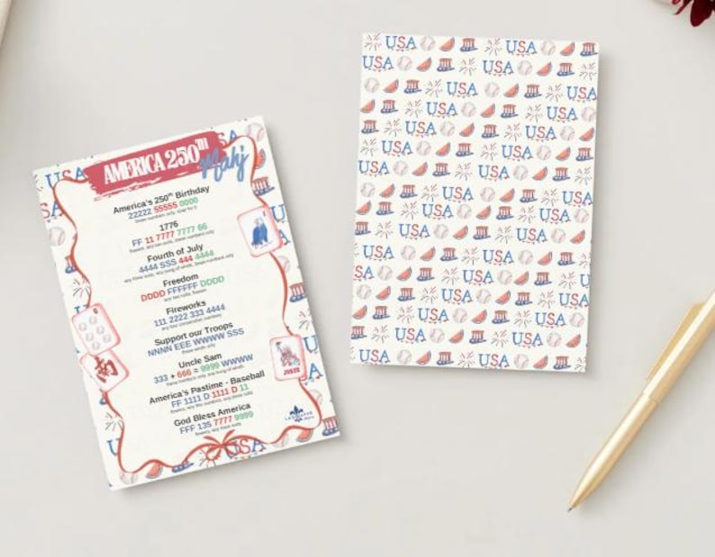 May include: Two patriotic cards with a gold pen. One card features the text "America 250th July" and contact information. The other card has a repeating pattern of "USA" with patriotic symbols in red, white, and blue.