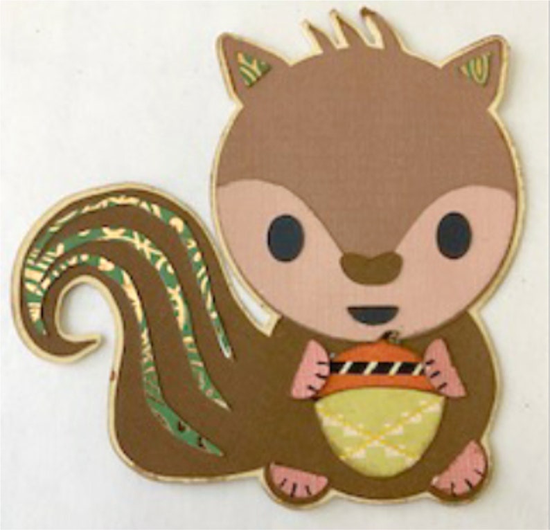 May include: A brown and green squirrel with a large, bushy tail holds a yellow and orange acorn in its paws. The squirrel has a pink nose and large, black eyes.