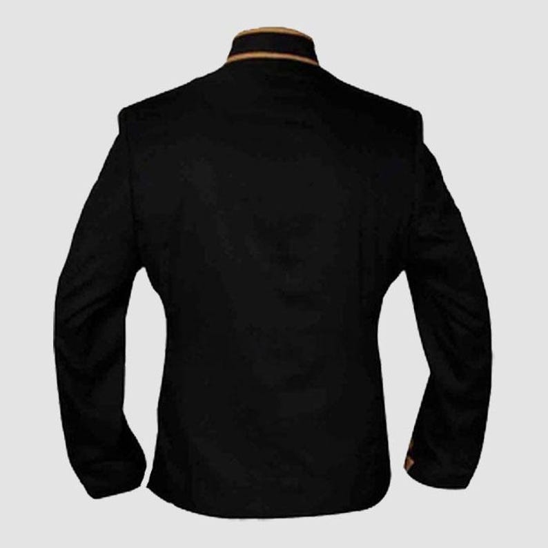 May include: A black blazer with long sleeves and a mandarin collar. The collar features a thin gold trim. The back of the jacket is visible, showcasing the tailored fit and design. The blazer is made of a smooth, dark fabric.