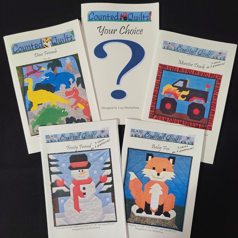 May include: Five counted cross stitch quilt patterns featuring a dinosaur, monster truck, snowman, fox, and a question mark. The patterns are titled "Dino Friends", "Monster Truck", "Frosty Friend", "Baby Fox", and "Your Choice".