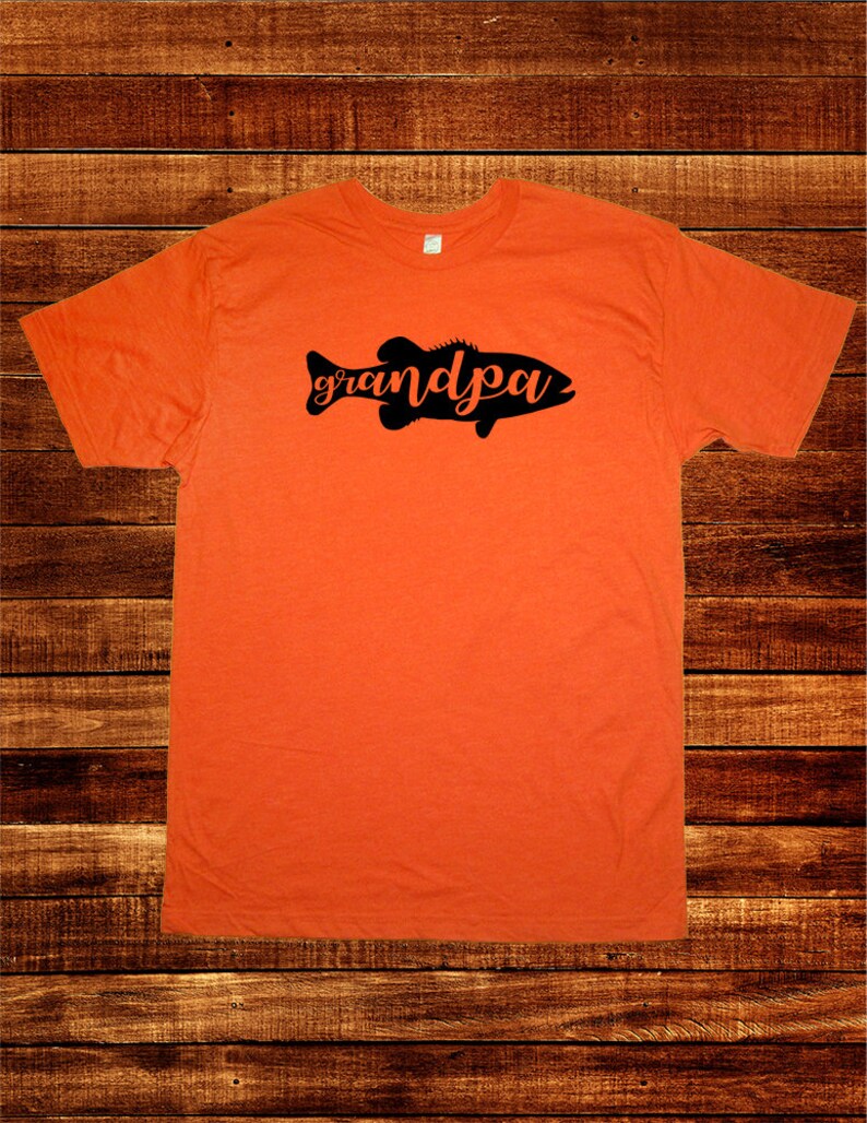May include: Orange t-shirt with a black silhouette of a fish with the word "grandpa" written inside the fish.