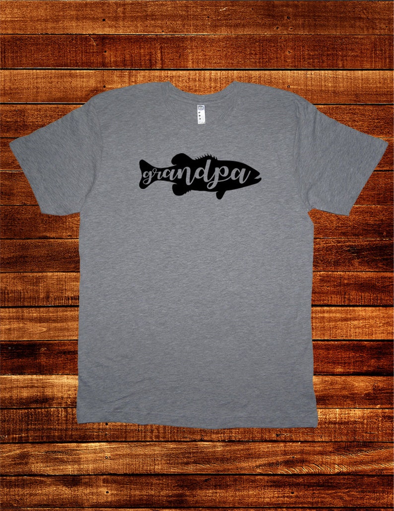 May include: A heather grey t-shirt with a black silhouette of a fish with the word "grandpa" written inside the fish.