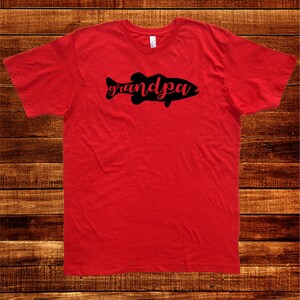 May include: Red t-shirt with a black silhouette of a fish with the word "grandpa" written inside the fish.