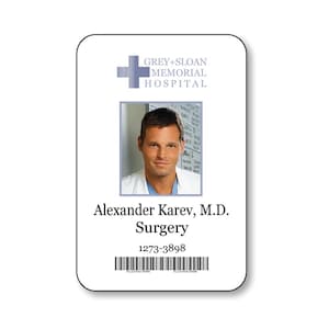May include: A rectangular white identification badge featuring the Grey+Sloan Memorial Hospital logo, a portrait of Alexander Karev, M.D. in the Surgery department, the identification number 1273-3898, and a black barcode at the bottom.