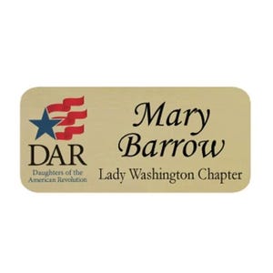 May include: A rectangular name badge with rounded corners. The badge is a light gold color and features the name "Mary Barrow" in elegant script. The DAR logo and "Lady Washington Chapter" are also displayed.
