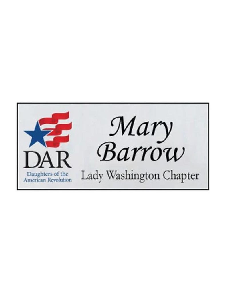 May include: A rectangular name badge with the text "Mary Barrow" in elegant script. The badge includes the DAR logo with a blue star and red stripes, and the text "Daughters of the American Revolution" and "Lady Washington Chapter".