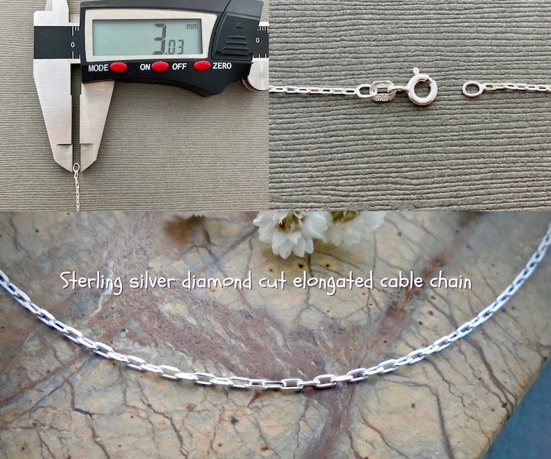 May include: A close-up of a silver diamond cut elongated cable chain. The chain is 3.03 mm wide. Sterling silver diamond cut elongated cable chain.