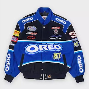 May include: A black and blue racing jacket featuring multiple embroidered logos including Oreo, Ritz, Nabisco, and Fig Newtons. The jacket has a stand-up collar, long sleeves with ribbed cuffs, a front snap button closure, and the number 3 on the sleeve.