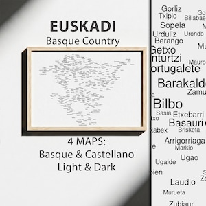 May include: A framed map print of Euskadi, Basque Country, featuring black text on a white background. The text reads EUSKADI Basque Country and 4 MAPS: Basque & Castellano Light & Dark. The frame is light wood, and the print displays numerous place names.