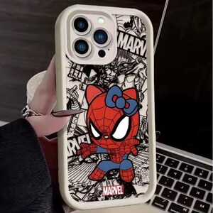 May include: A white phone case featuring a cartoon character that is a hybrid of Hello Kitty and Spider-Man. The character is red and blue with a blue bow. The background is a black and white comic book style design with the word "MARVEL".