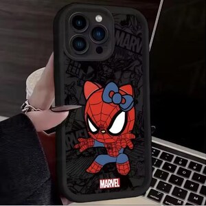 May include: Black phone case featuring a cartoon Spider-Man character with a Hello Kitty-inspired design. The case has a red and blue color scheme, with the Marvel logo at the bottom. The background has a comic book style.