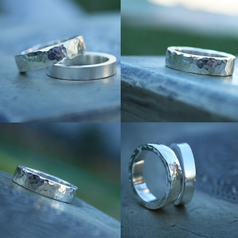 May include: Two silver hammered rings, one stacked on top of the other. The rings are both wide and have a textured surface.
