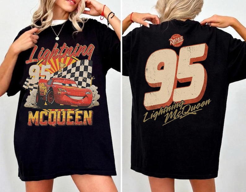 May include: Black t-shirt featuring Lightning McQueen from the Cars movie. The front graphic shows McQueen with the number 95, a checkered flag, and the text "Lightning McQueen". The back of the shirt displays the number 95 and "Lightning McQueen".